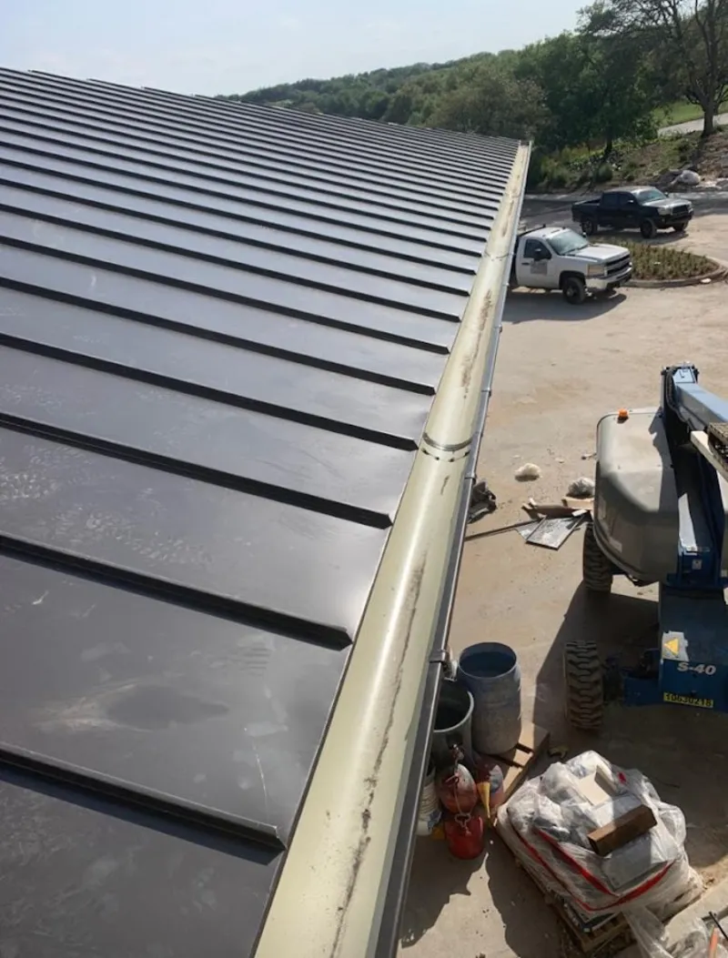 Standing seam panel and gutter detail on a metal roofing jobsite in Granite Bay